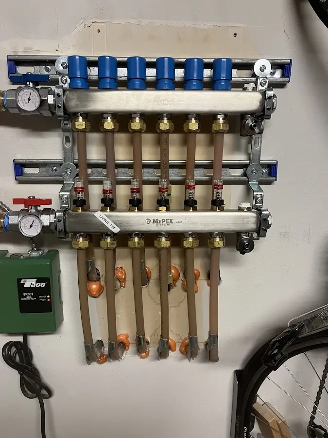 Plumber performing Water Heater Repair at a residential property in Le Claire